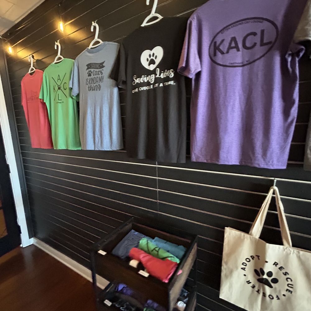 Kitten Around Cat Lounge - t - shirts hanging on a wall - Themed Cafes Near Me - Carthage, North Carolina