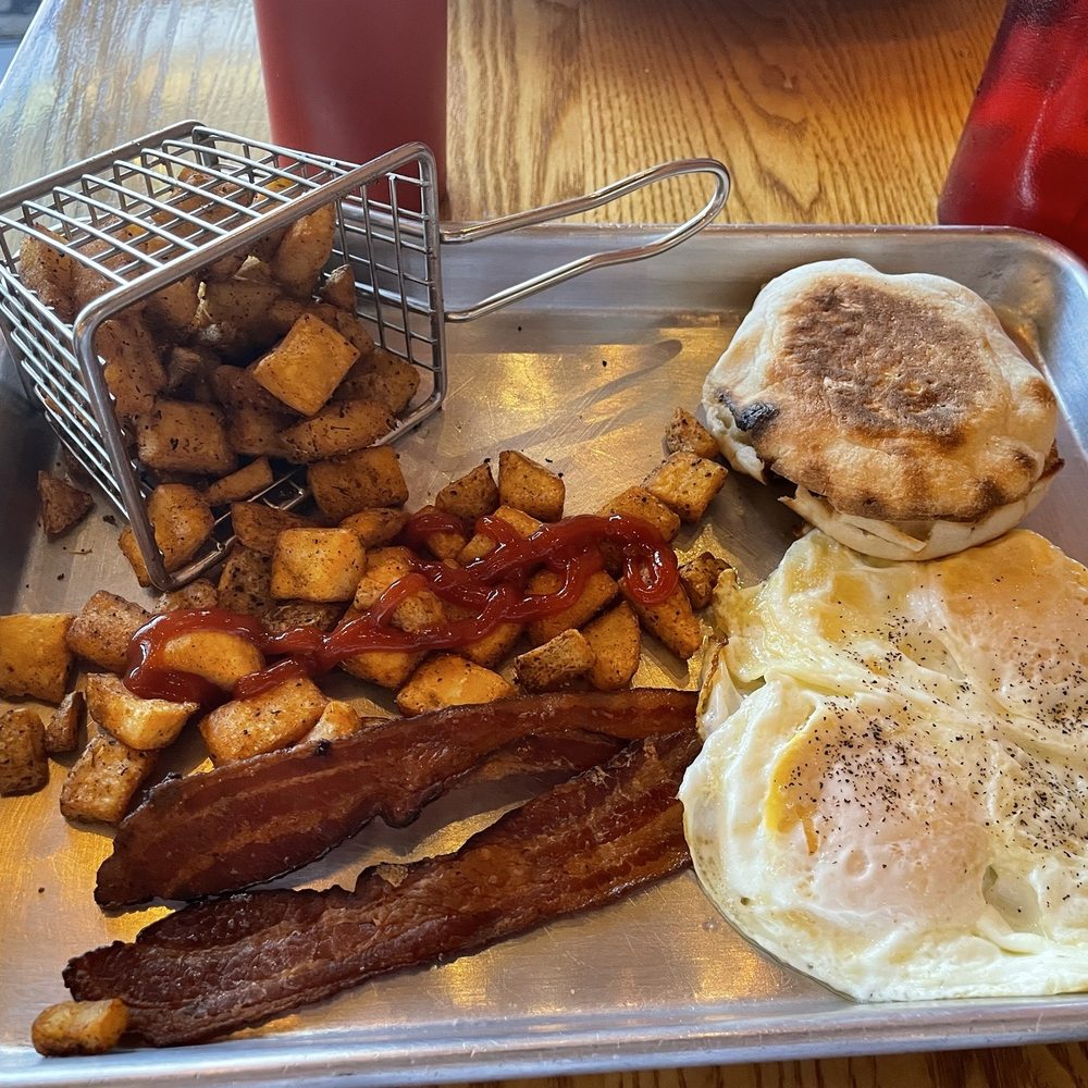 Eggs bacon English muffin potatoes and Arkansas breakfast burrito