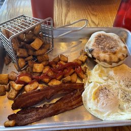 Eggs bacon English muffin potatoes and Arkansas breakfast burrito