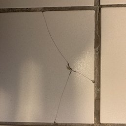 Cracked tile in the "newly remodeled" bathroom.