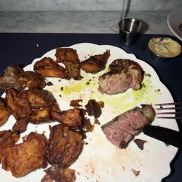 Steak plater  Top right is the blob of fat we got on our dish .