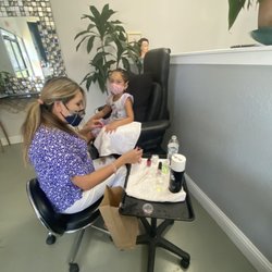 Divina Cosmetology & Barbering Academy - Patty finishing a manicure and pedicure