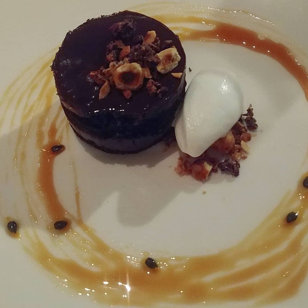 L'Etoile - chocolate cake with hazelnuts, passion fruit caramel, and coconut sorbet - vegan and INSANELY PERFECT - New American Near Me - Madison, Wisconsin L'Etoile - chocolate cake with hazelnuts, passion fruit caramel, and coconut sorbet - vegan and INSANELY PERFECT - New American Near Me - Madison, Wisconsin