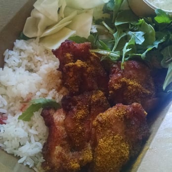 Aburaya - 4 piece japanese fried chicken with curry powder over rice and arugula. ($9) Perfectly fried, moist and flavorful curry. - Izakaya Near Me - Oakland, California