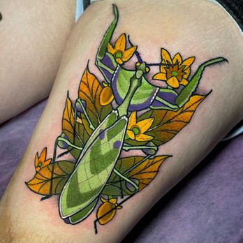 Remington Tattoo Parlor - Left Thigh Tattoo - a purple and green devils flower mantis from above, framed by yellow flowers and green/brown leaves - Tattoo Near Me - San Diego, California