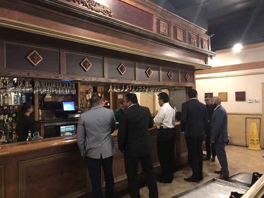 Photo of The Palace Lounge - Upland, CA, US. a group of men standing at the bar