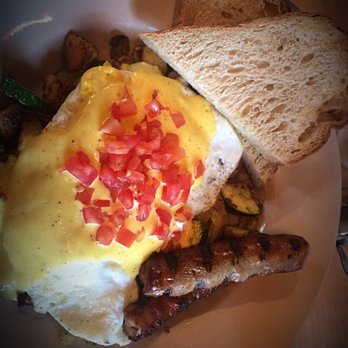 Crow's Nest - Special Skillet: 2 over medium eggs, pork sausage, potatoes, onion, mushrooms, zucchini, garlic, tomato, hollandaise sauce & bread - Breakfast & Brunch Near Me - Kalamazoo, Michigan Crow's Nest - Special Skillet: 2 over medium eggs, pork sausage, potatoes, onion, mushrooms, zucchini, garlic, tomato, hollandaise sauce & bread - Breakfast & Brunch Near Me - Kalamazoo, Michigan