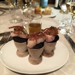 Hamachi (yellow tail) Sashimi served on a black masa (corn) cracker
