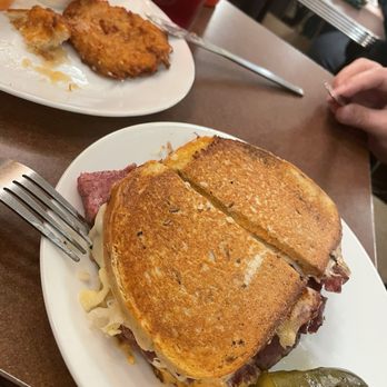 S&P - Hot Reuben Corned Beef Sandwich and latkes in the back - Sandwiches Near Me - New York, New York