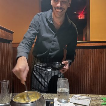 The Melting Pot - Cheese fondue being stirred by our server - Fondue Near Me - Tallahassee, Florida The Melting Pot - Cheese fondue being stirred by our server - Fondue Near Me - Tallahassee, Florida
