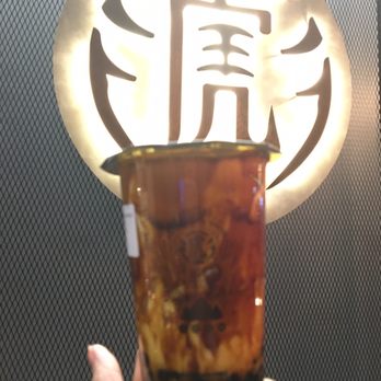 Tiger Sugar - a hand holding a glass of iced tea - Bubble Tea Near Me - Scarborough, Ontario