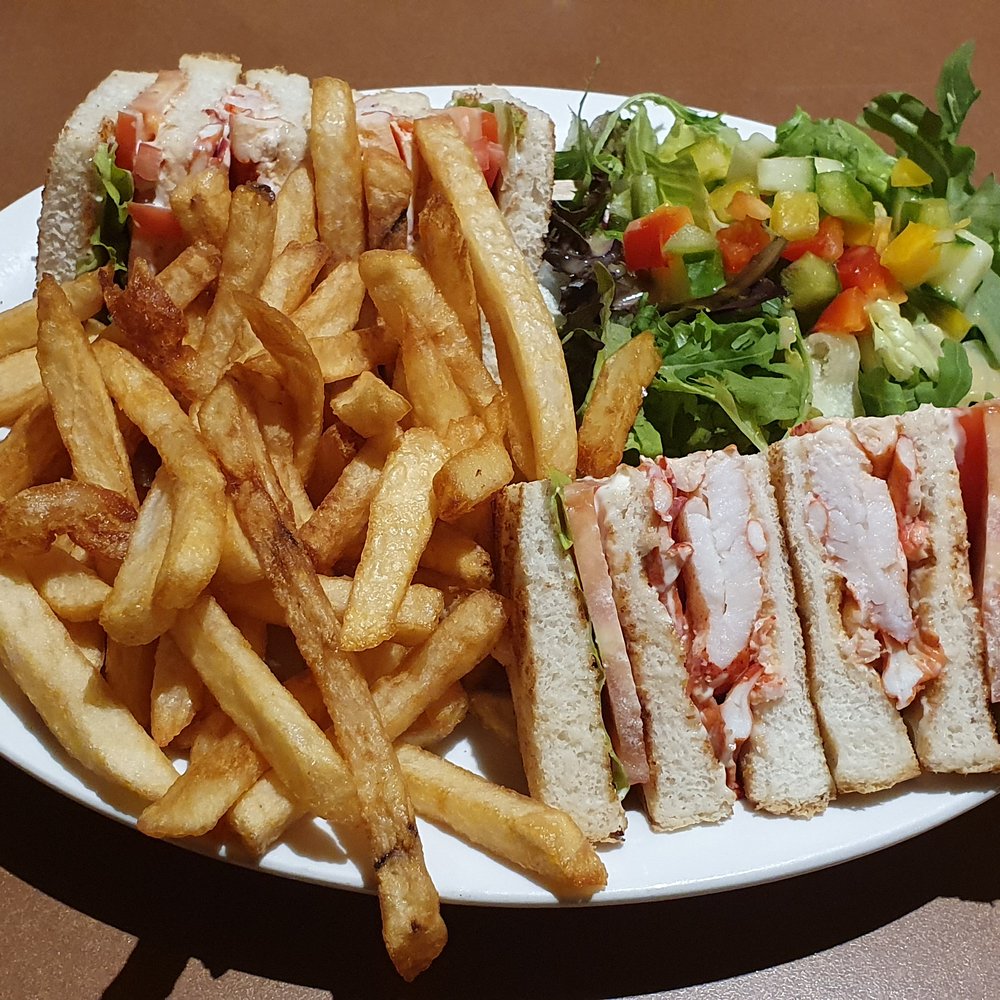 Brise-Bise - a plate of french fries and a club sandwich - Seafood Near Me - Gaspé, Quebec