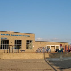 Mohawk Elementary - Elementary school and Kindergarten playground in photo. Large windows with name is the Cafeteria. 7/30/2021