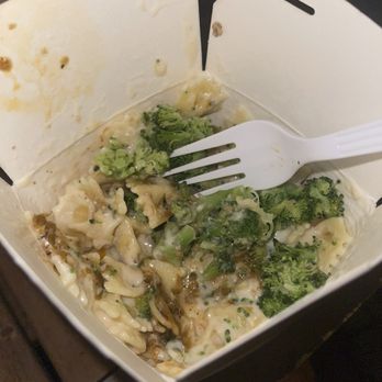 PastaFi - Alfredo - A partially eaten pasta dish with broccoli in a takeout box, with a white plastic fork inside. - Pasta Shops Near Me - Chicago, Illinois