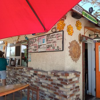 Woodys - the outside of a restaurant with a red umbrella - Burgers Near Me - Fallon, Nevada Woodys - the outside of a restaurant with a red umbrella - Burgers Near Me - Fallon, Nevada