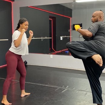 Just Kickin’ It kickboxing - Instructor Correy showing the proper form for a round kick. - Kickboxing Near Me - Chula Vista, California Just Kickin’ It kickboxing - Instructor Correy showing the proper form for a round kick. - Kickboxing Near Me - Chula Vista, California