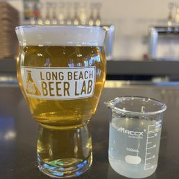a glass of beer and a beaker a glass of beer and a beaker