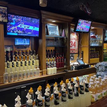 Sam's Steak & Grill - a bar filled with bottles of liquor - American Near Me - Valley Stream, New York