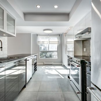 Wang Construction - a kitchen with stainless steel appliances - General Contractors Near Me