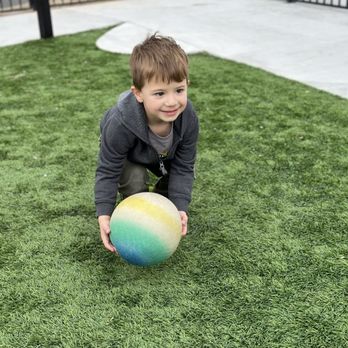 Blue Kangaroo Learning Center - The Blue Kangaroo Learning Center class playing outside on the lawn - Child Care & Day Care Near Me - Reno, Nevada
