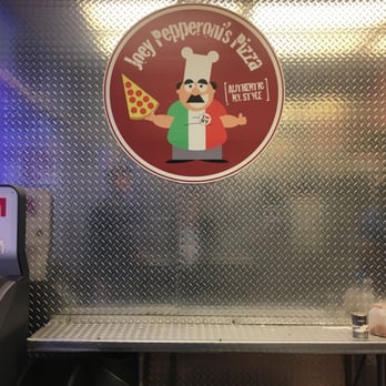 Joey Pepperoni's Pizza - a table with a pizza on it - Pizza Near Me - West Bronx, New York Joey Pepperoni's Pizza - a table with a pizza on it - Pizza Near Me - West Bronx, New York