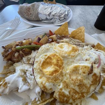 Los Dos Toritos - Chilaquiles plate and burrito in the background. - Seafood Near Me - Baker, California Los Dos Toritos - Chilaquiles plate and burrito in the background. - Seafood Near Me - Baker, California