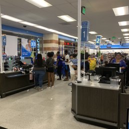 Two cashiers working on a Friday night.