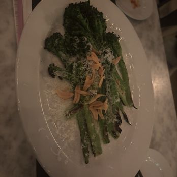 White Pie - Broccolini - Grilled broccolini with sliced almonds and grated cheese served on a white oval plate, likely at a restaurant. - Pizza Near Me - Denver, Colorado