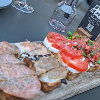 Postino Del Mar - Bruschetta board: 1. Salami-pesto, 2. Prosciutto-fig-mascarpone, 3. Mozzarella-tomato-basil and 4. Burrata-bacon-arugula-tomato - Wine Bars Near Me - San Diego, California Postino Del Mar - Bruschetta board: 1. Salami-pesto, 2. Prosciutto-fig-mascarpone, 3. Mozzarella-tomato-basil and 4. Burrata-bacon-arugula-tomato - Wine Bars Near Me - San Diego, California