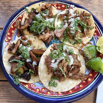 Mole Mole - 2 Al pastor tacos on the left and 2 carnita tacos on the right - Mexican Near Me - Portland, Oregon Mole Mole - 2 Al pastor tacos on the left and 2 carnita tacos on the right - Mexican Near Me - Portland, Oregon