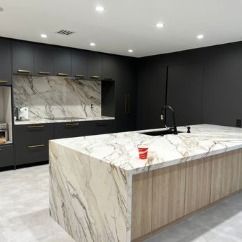 Tower Construction & Management - a kitchen with a marble island - General Contractors Near Me