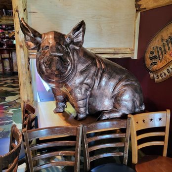 Rusty Bison - a statue of a bull sitting on a table - Barbeque Near Me - Cooperstown, New York Rusty Bison - a statue of a bull sitting on a table - Barbeque Near Me - Cooperstown, New York