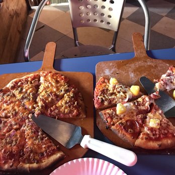 The Pizza Joint - two slices of pizza on cutting boards - Bars Near Me - Marion, North Carolina
