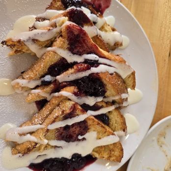 Rooster - Downtown - French toast with berries and cream drizzle - Creperies Near Me - St. Louis, Missouri Rooster - Downtown - French toast with berries and cream drizzle - Creperies Near Me - St. Louis, Missouri