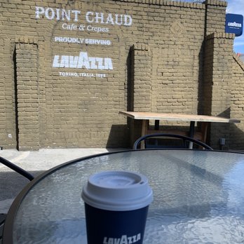Lavazza - a cup of coffee sitting on a table - Creperies Near Me - Washington, DC, District of Columbia