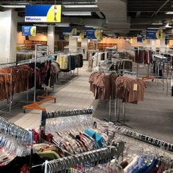 Planet Aid Thrift Store - Racks of men's and women's clothing.
