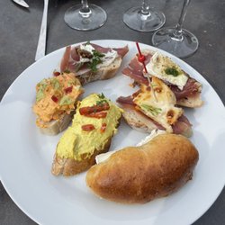 Play of a bunch of different mini-sandwiches. 4 are ham with different cheeses. Two are chicken (curry and another). All fantastic.