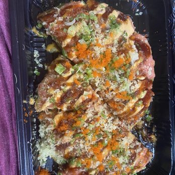 Liu's Kitchen - Tuna Pizza - flavorless cat food - Three sushi pieces in a black plastic container are topped with sauces, chopped green onions, and orange fish roe, garnished with crunchy tempura flakes. - Chinese Near Me - Brick, New Jersey