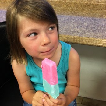 Jorge's Paleteria & Neveria - a young girl holding a popsicle - Ice Cream & Frozen Yogurt Near Me - West Chicago, Illinois