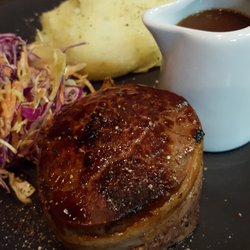 Bacon wrapped eye filet with slaw and truffle mash and peppercorn sauce
