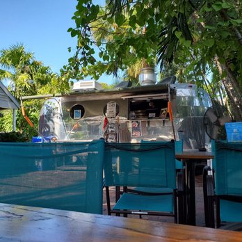 Garbo's Grill - a table and chairs in front of a food truck - Food Trucks Near Me - Key West, Florida Garbo's Grill - a table and chairs in front of a food truck - Food Trucks Near Me - Key West, Florida