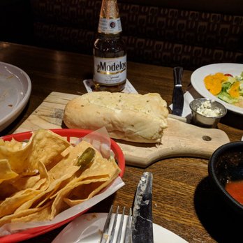 Primo's De Tico's - a plate of nachos and a bottle of beer - Mexican Near Me - Carthage, New York Primo's De Tico's - a plate of nachos and a bottle of beer - Mexican Near Me - Carthage, New York