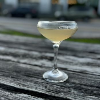 La Holly - a glass of wine sitting on a wooden table - Tacos Near Me - Austin, Texas