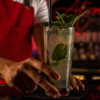 Atomic Lounge and Bar - a bartender holding a mojita - Latin American Near Me - Miami, Florida