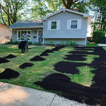Precise Lawn Care - a man with a wheelbarrow and a wheelbarrow in front of a house - Landscaping Near Me - Berea, Ohio Precise Lawn Care - a man with a wheelbarrow and a wheelbarrow in front of a house - Landscaping Near Me - Berea, Ohio