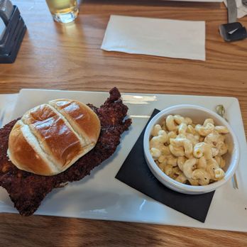 Bespoke Brewing - Spicy Chicken and mac-n-cheese. Match made in heaven - A meal featuring fried fish with a bread roll and a bowl of macaroni and cheese on a rectangular white plate, with a drink and fries in the background. - Breweries Near Me - Ronks, Pennsylvania