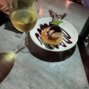 The Black Marlin - It's the birthday desert they made for us! It's a fried doughnut with ice-cream and the sauce is raspberry sauce. - Seafood Near Me - Tustin, California