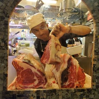 La Buchetta - One of the chefs showing off their cuts in a cut-out to the sidewalk - Tuscan Near Me - Florence, FI La Buchetta - One of the chefs showing off their cuts in a cut-out to the sidewalk - Tuscan Near Me - Florence, FI