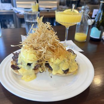 Fleur STL - Seasonal Short Rib Eggs Benedict with a Mimosa - Breakfast & Brunch Near Me - St. Louis, Missouri Fleur STL - Seasonal Short Rib Eggs Benedict with a Mimosa - Breakfast & Brunch Near Me - St. Louis, Missouri
