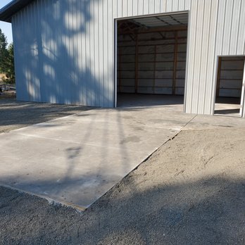 MacArthur Contractors - a concrete driveway being laid in front of a garage - Roofing Near Me MacArthur Contractors - a concrete driveway being laid in front of a garage - Roofing Near Me
